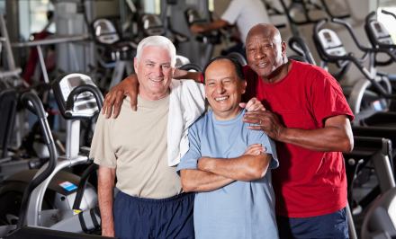 Three mature men in a gym